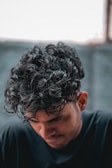 a close up of a person with curly hair