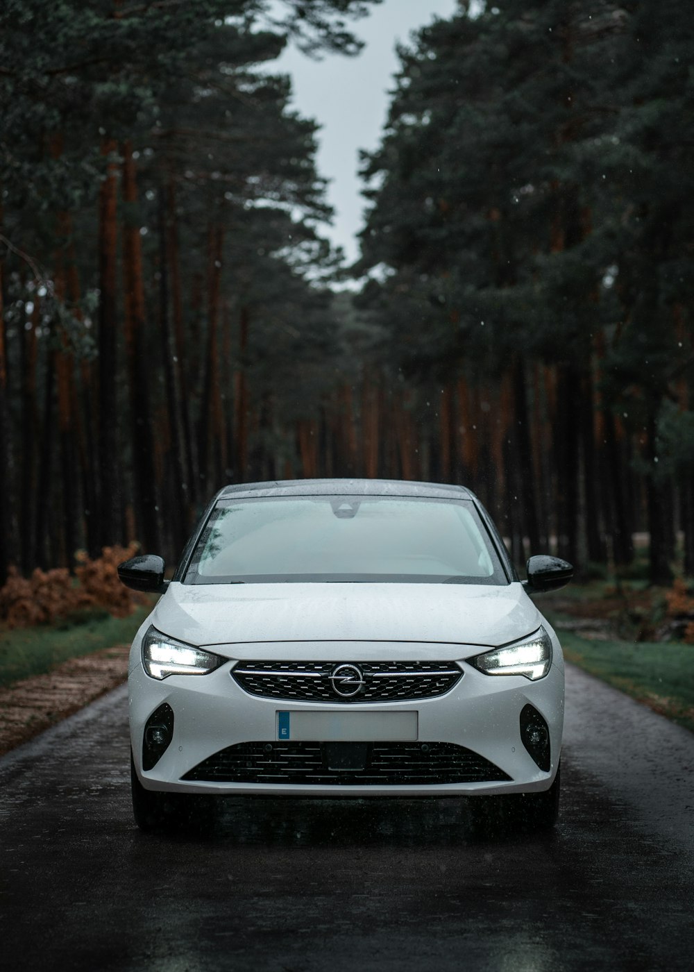 a white car parked on the side of a road