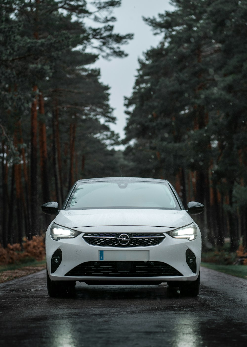 a white car parked on the side of a road