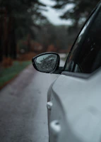 a side view mirror on a white car