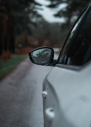 a side view mirror on a white car
