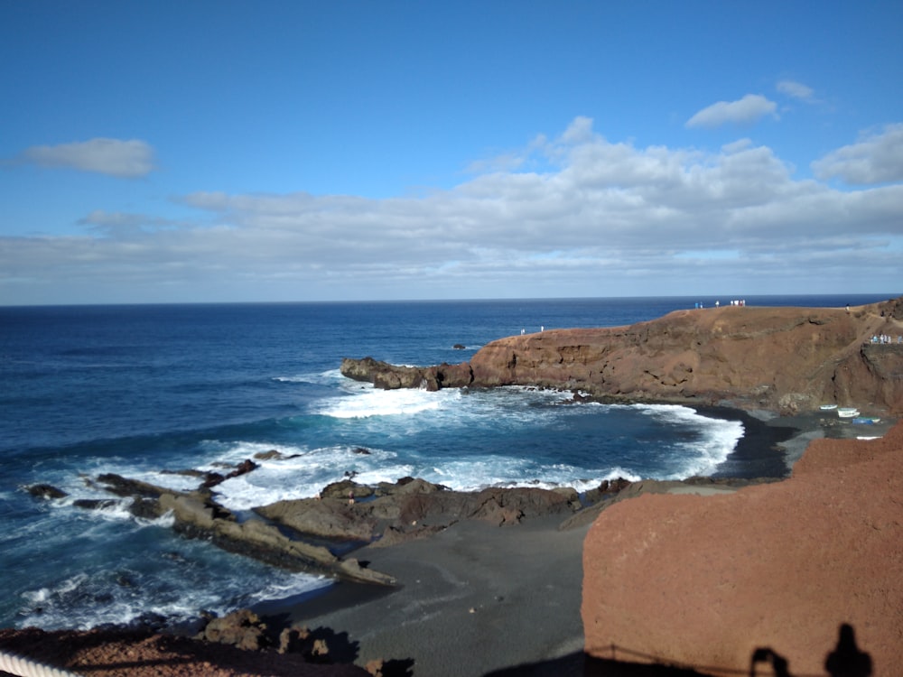 a view of the ocean from the top of a hill