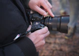 Close-up of a photographer adjusting camera settings during an outdoor event