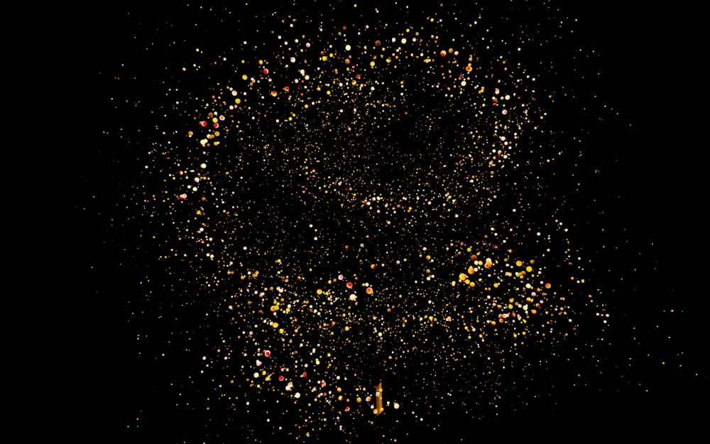 a black background with yellow and red speckles