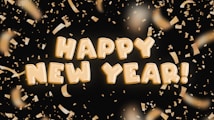 Golden text spelling out 'Happy New Year!' surrounded by shimmering golden confetti against a dark background.