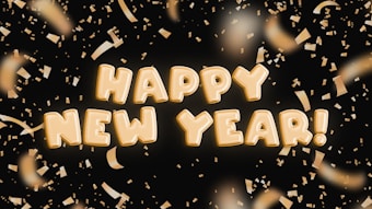 Golden text spelling out 'Happy New Year!' surrounded by shimmering golden confetti against a dark background.