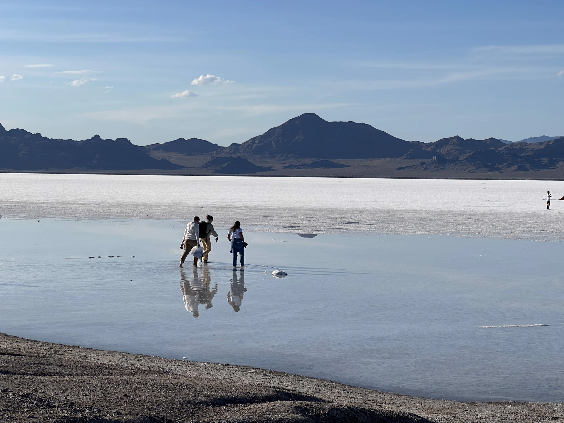 a group of people walking across a large body of water