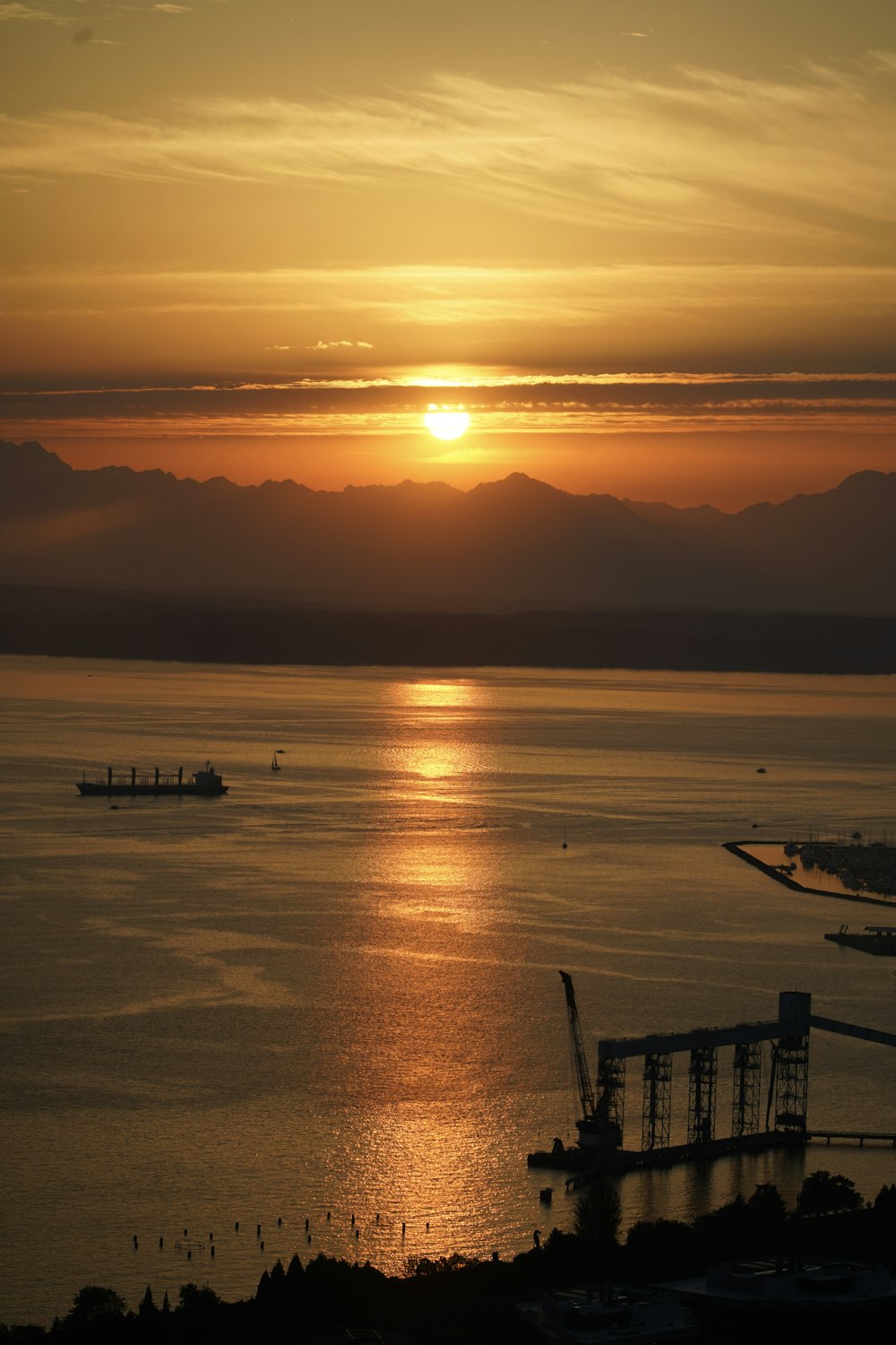 a large body of water with a sunset in the background