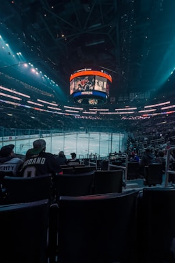 a hockey stadium filled with fans watching a game