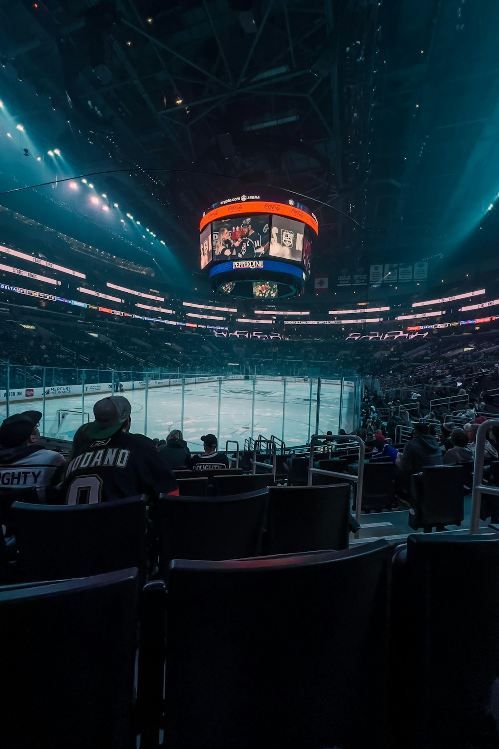 a hockey stadium filled with fans watching a game