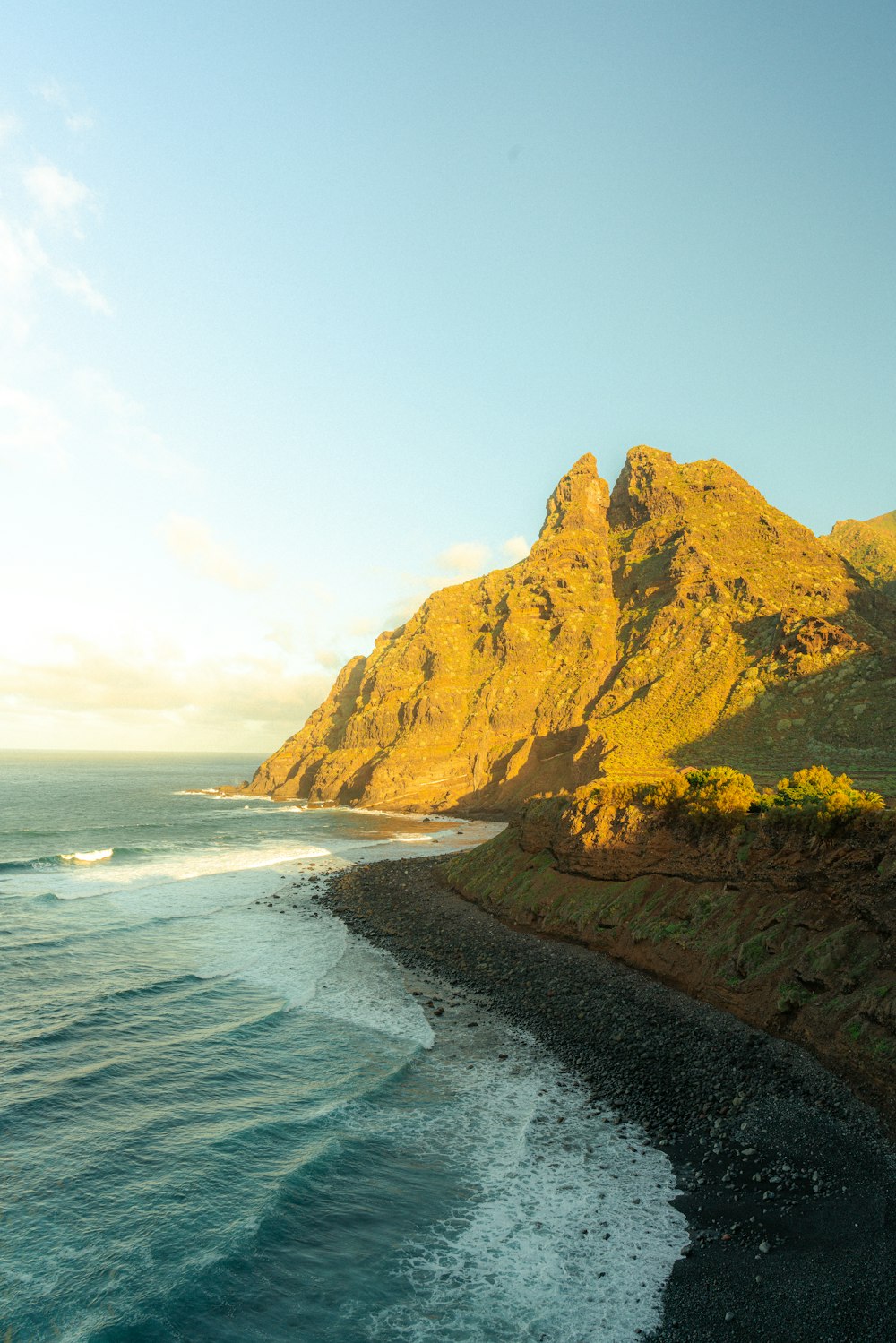 a view of a beach with a mountain in the background