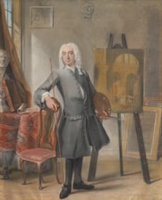 An 18th-century artist stands in a studio, holding a palette and brush, beside an easel with a partially completed painting of an architectural scene. The room contains a classical bust and an ornate draped chair.
