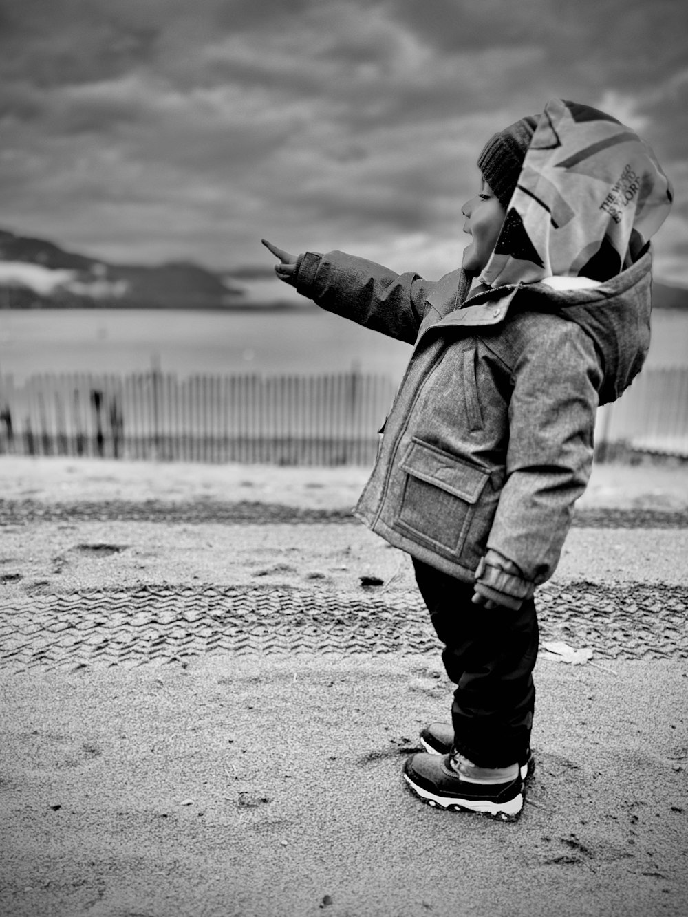 a young boy standing on top of a skateboard