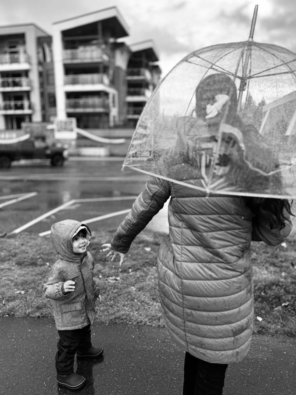 a woman holding an umbrella over a small child