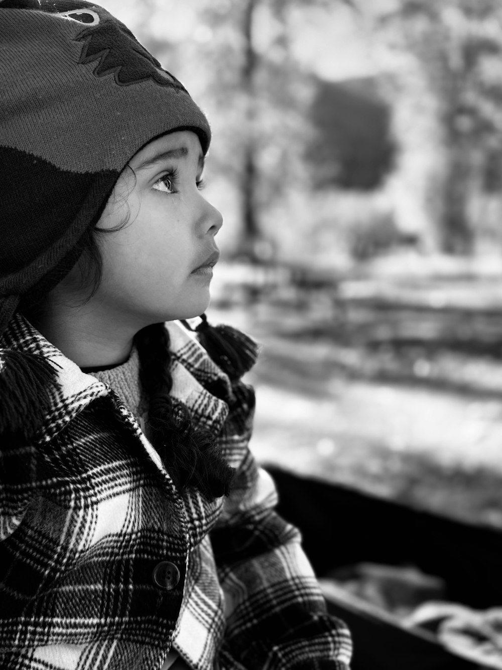 a small child wearing a hat and coat