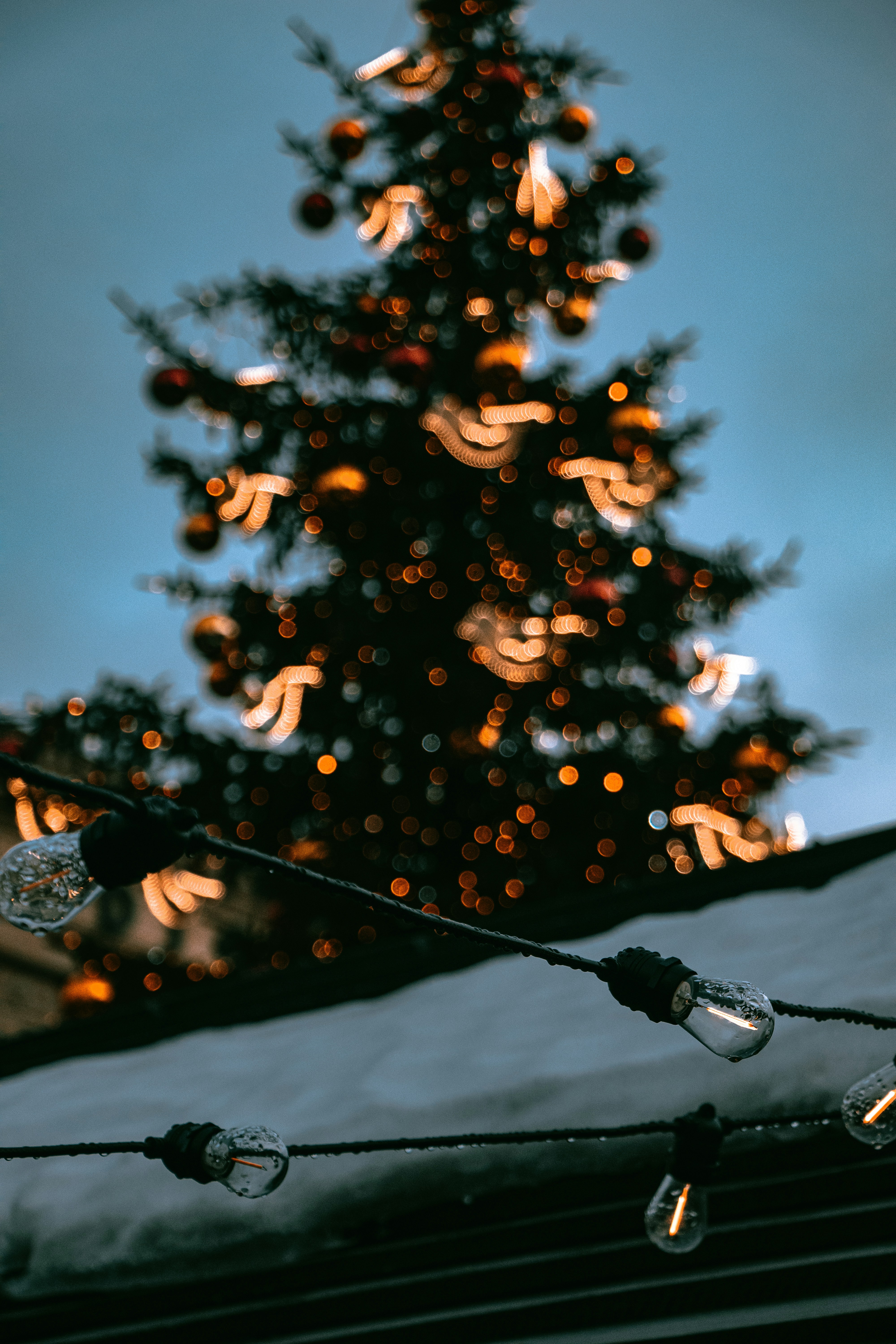a christmas tree with lights in front of it