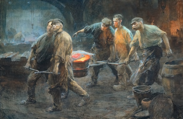 A group of workers in an industrial setting, wearing worn clothes and caps, are carrying a large piece of hot, glowing metal using long rods. The environment is dim and rugged, with a warm glow illuminating them and a shadowy background.
