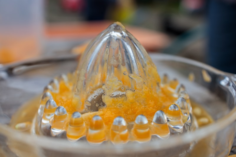 Close-up of a blender filled with fresh orange juice