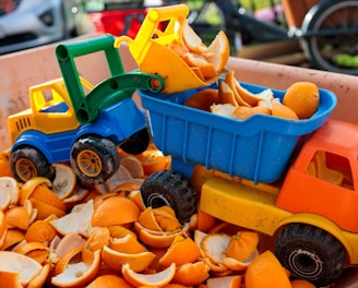 a toy truck filled with orange peels in a bin