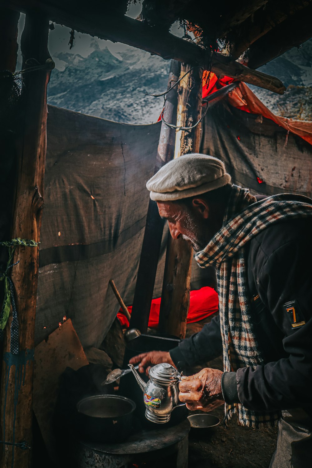a man is cooking food in a tent