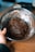 Close-up of hands mixing chocolate ingredients in a bowl.