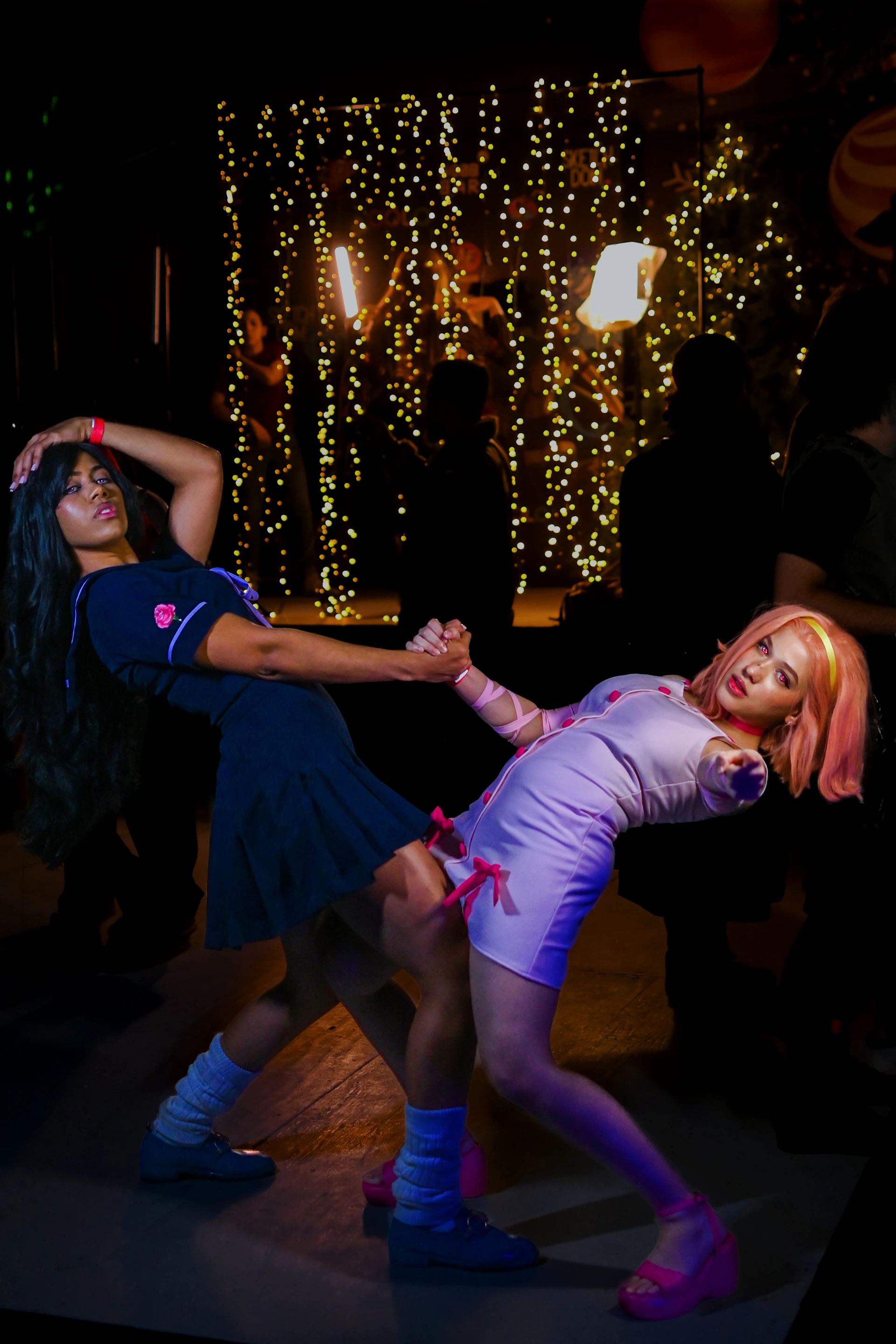 A vibrant photo of Xindy and Tzy Liang smiling outdoors, dressed in sporty purple and yellow activewear, radiating energy and health.