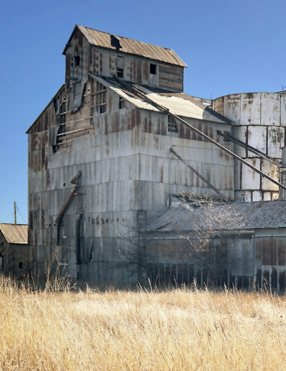 an old grain silo in a field of dry grass