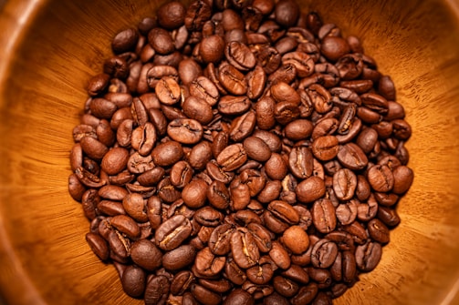 Close-up of a roasted cherry coffee bean blend in a rustic bowl.