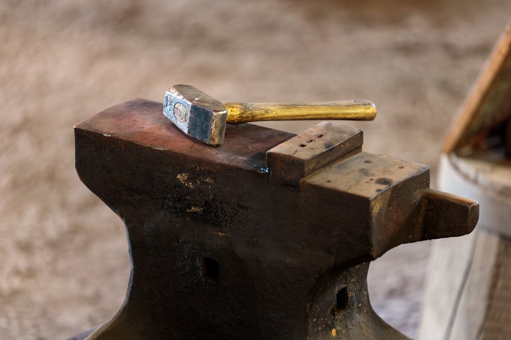 a hammer and a block of wood on top of a bench