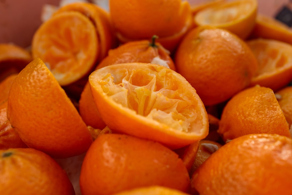 a pile of oranges that are cut in half