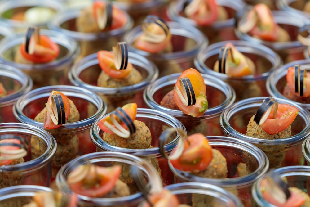a close up of many small jars of food