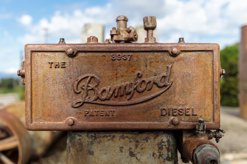 a rusted metal sign on a rusty pipe