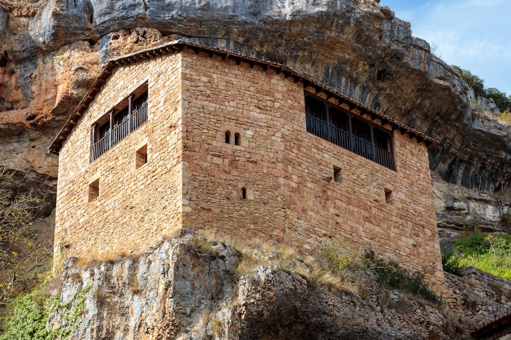 a stone building built into the side of a mountain