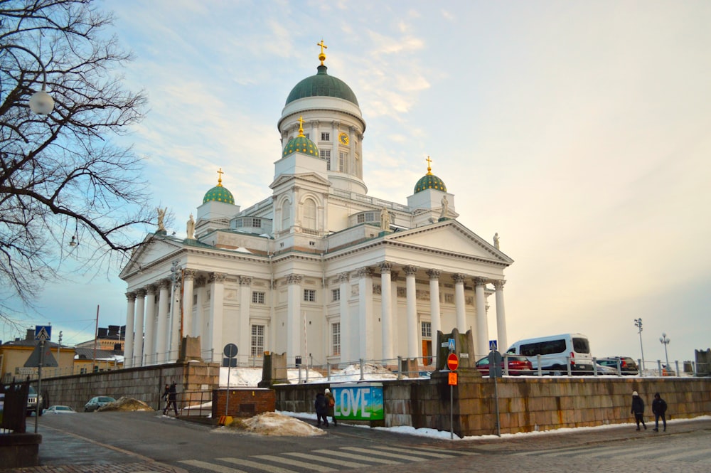 a large white building with a green dome