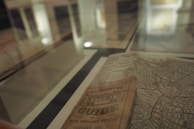 An old map and handwritten notes displayed under glass in Maktaiba Taybah’s exhibition area.