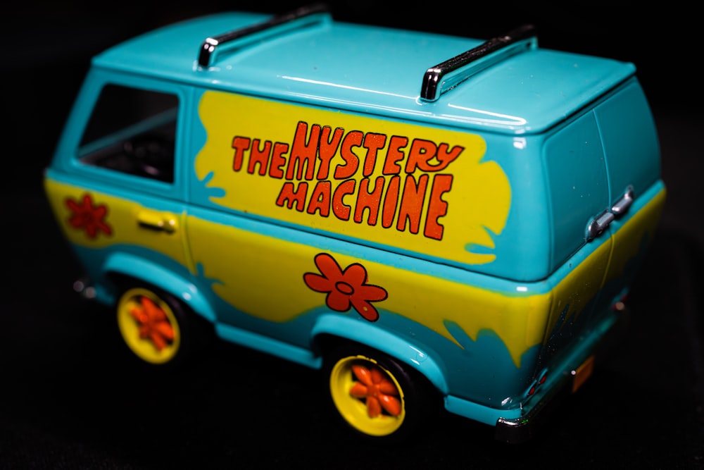 a toy van with the words mystery machine painted on it