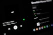 A dark-themed Spotify interface displaying the song 'See The Light' by Swedish House Mafia featuring Fridayy. The play controls are visible with options to play, pause, and skip tracks. The track list and album details are slightly blurred in the background.