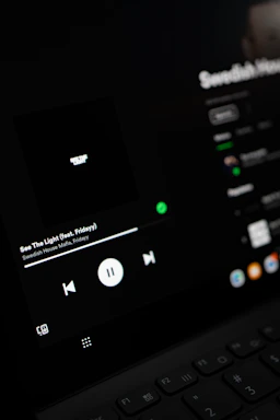 A vibrant music player interface showing a play icon next to each song title.