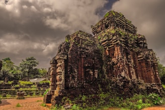 Moss-covered stone carvings of Bayon temple surrounded by lush jungle.