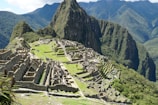 A panoramic view of ancient stone pathways leading through Andean hills