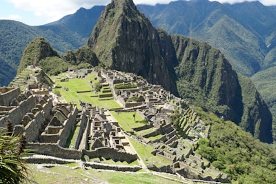 A panoramic shot of the Inca ruins surrounded by lush mountains.