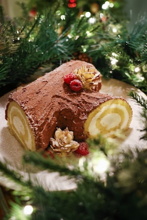 A beautifully arranged gluten-free yule log cake with natural decorations.