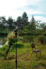 A solemn ceremony setup with flowers and a microphone in a peaceful outdoor setting.