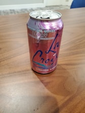 A refreshing glass of flavored water with a branded can.