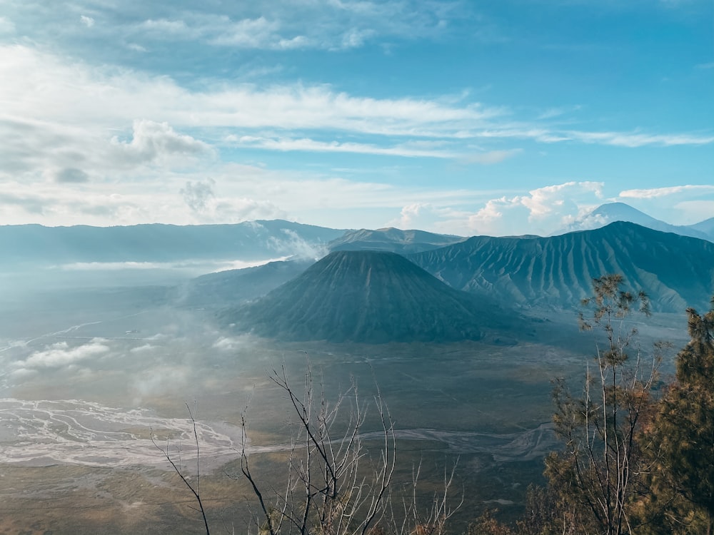 a view of a mountain range with clouds in the sky