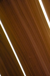 Modern MDF facade panels stacked neatly, showcasing smooth finishes and sharp edges under soft lighting.