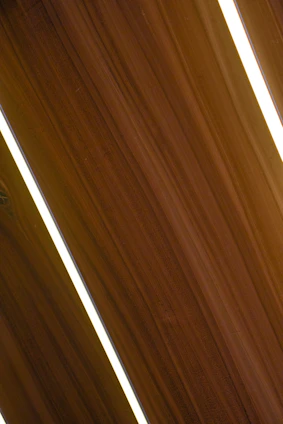 Modern interior wall installation with sleek drywall panels in a dark, elegant room accented by golden details.