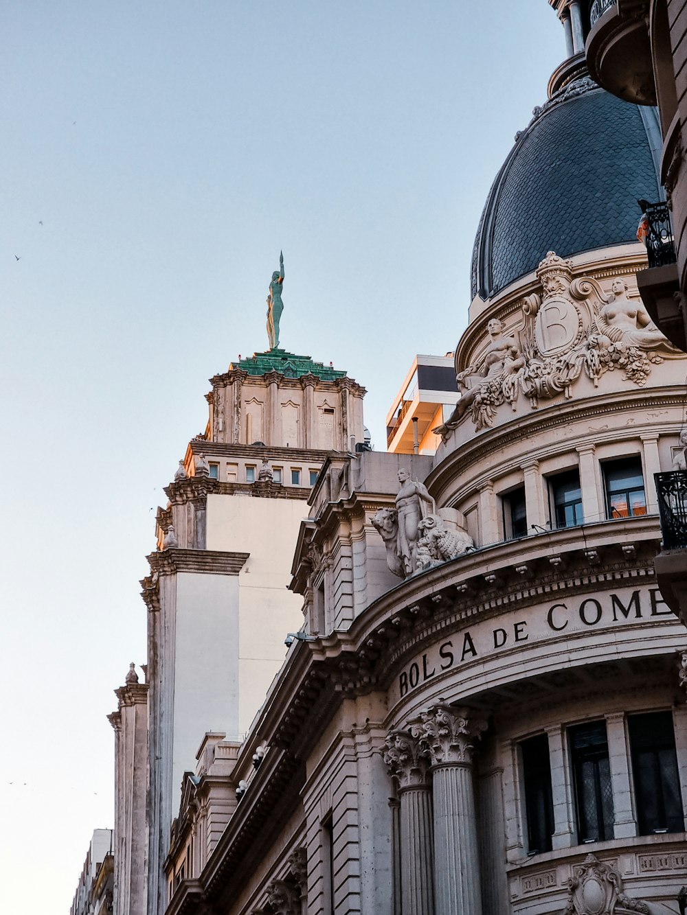 a tall building with a statue on top of it