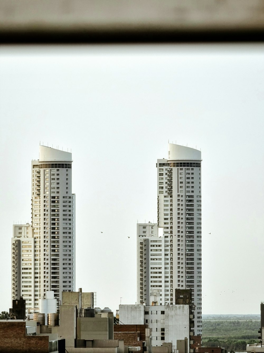 a view of some very tall buildings from a window