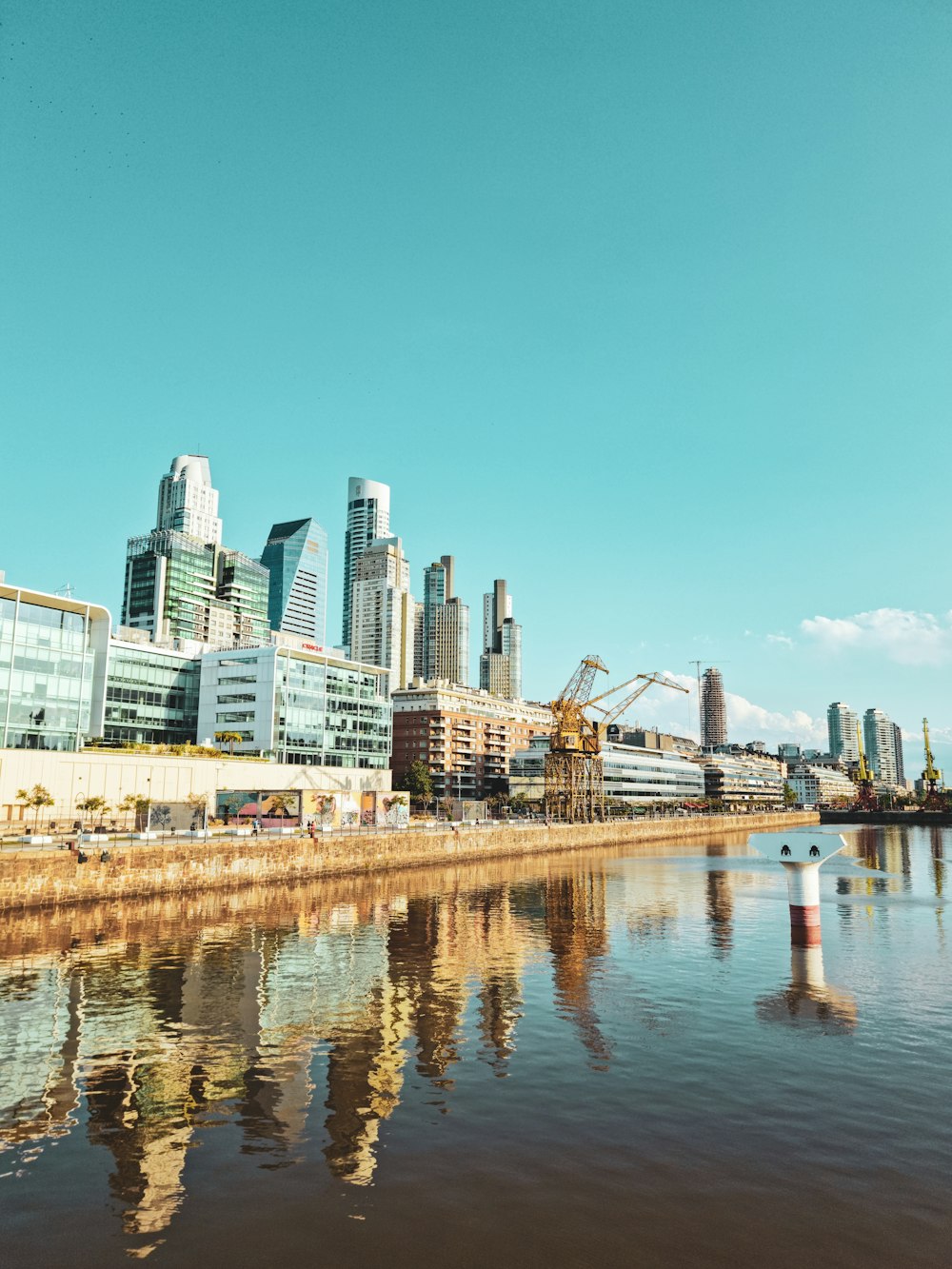 a body of water with a city in the background